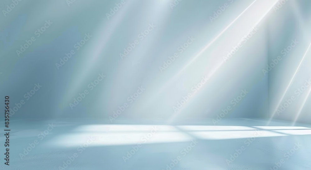 Abstract light blue background with a soft gradient, a white spotlight and rays of light on an empty studio room wall for a product display presentation design Abstract light blue background with a soft gradient, a white spotlight and rays of light on an empty studio room wall for a product display presentation design