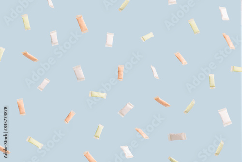 Tableau sur toile Different snus sachets with different flavors spill out of a plastic jar
