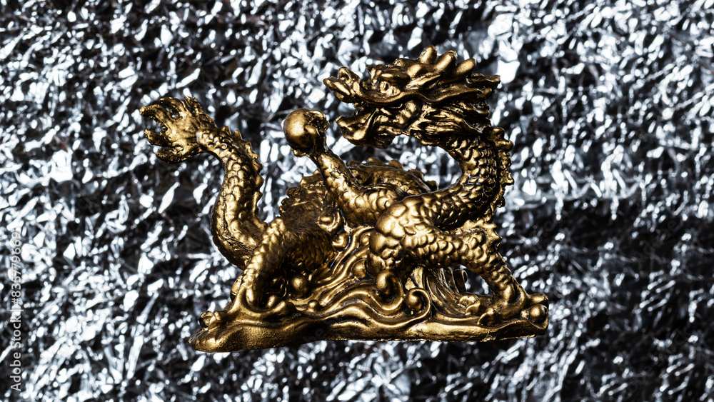 Fototapeta premium Golden dragon on a silver background. Chinese culture