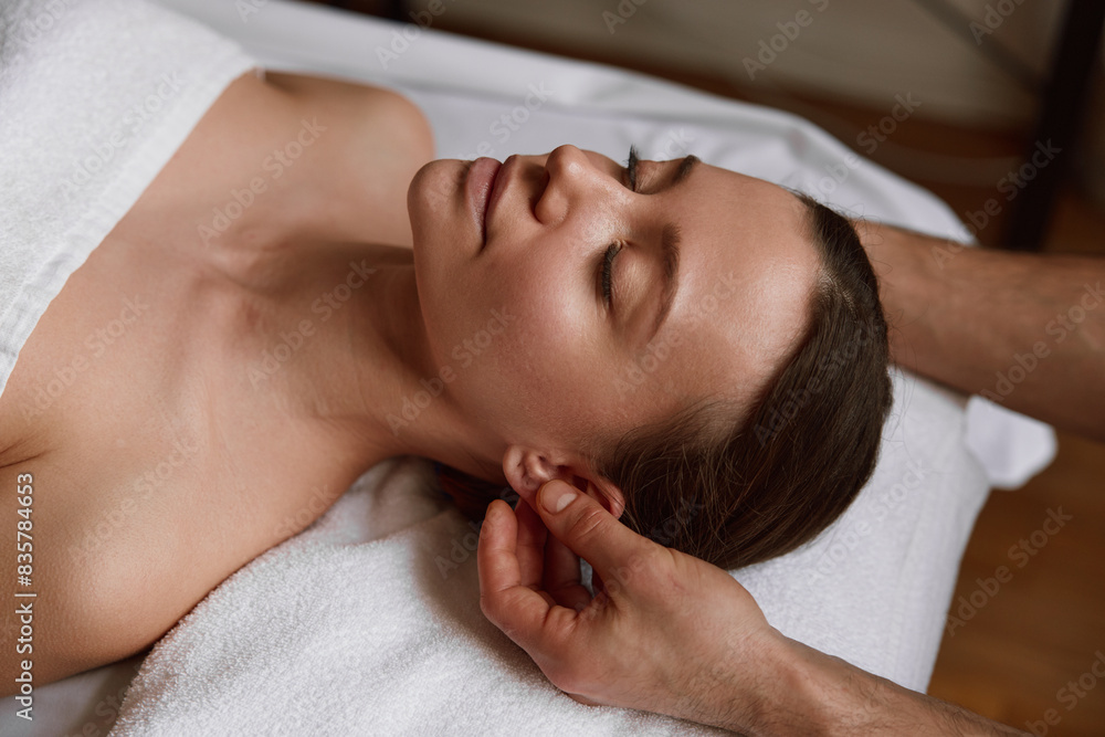 Peaceful female face at massage session in spa center Peaceful female face at massage session in spa center