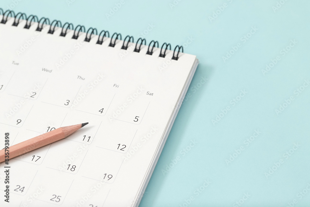 calendar month schedule to make appointment meeting or manage timetable each day lay and pen on yellow background for planning work and travel concept. calendar month schedule to make appointment meeting or manage timetable each day lay and pen on yellow background for planning work and travel concept.