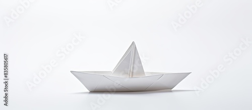 A white paper boat origami with a white background and copy space image.