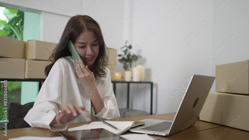 Young female entrepreneur is packing merchandise at home. Young female entrepreneur is packing merchandise at home.
