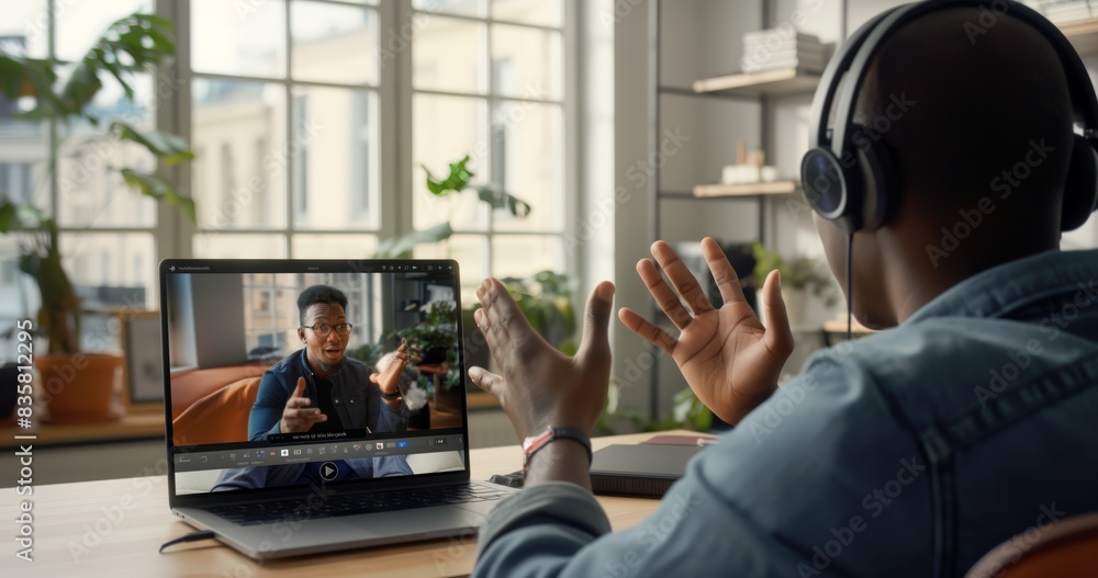 Fototapeta premium Engage in virtual meetings using a laptop and headphones for effective online communication in remote work. Stay connected through digital interactions to enhance collaboration in modern workspace