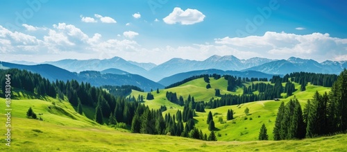 Scenic mountain landscape with dark blue skies and fluffy clouds, ideal for adding text or images with a lack of elements in the foreground - copy space image.