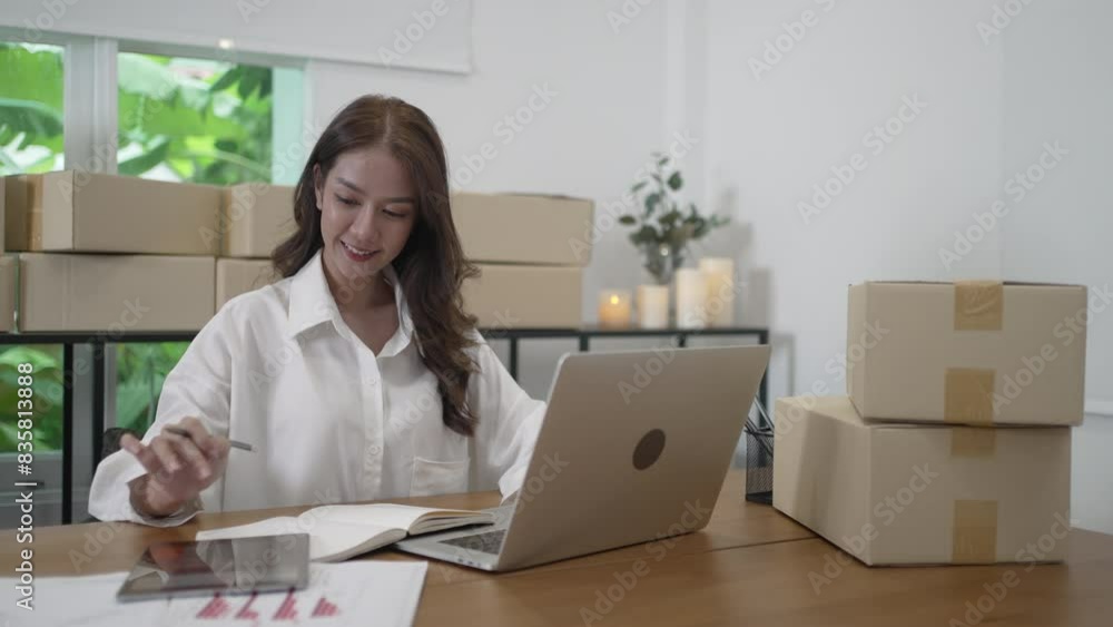 Young female entrepreneur is packing merchandise at home. Young female entrepreneur is packing merchandise at home.