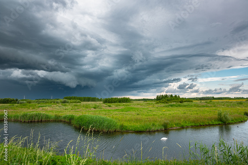 Beautiful landscape image of a heavy thunderstorm over Bentwoud nature reserve in western Netherlands