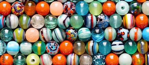 Handmade Murano and Venetian glass bright colorful beads on a vivid glass background perfect for a copy space image. photo