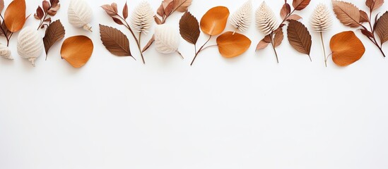Elegant autumn arrangement with eucalyptus, cotton flowers, and dried leaves on a soft gray backdrop. Represents the fall season. Top view with ample copy space image.