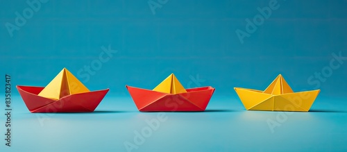 Colorful paper boats shaped like trees on a white backdrop with copy space image.