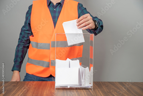 Canvastavla A voter casting a ballot into a ballot box on election day