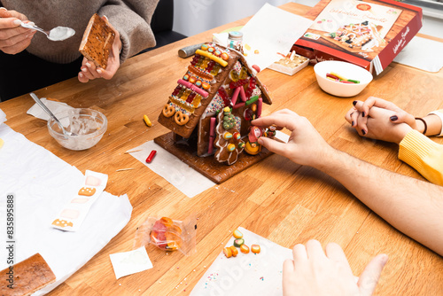 A group of young people design gingerbread cookies house