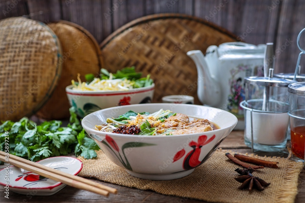 Asian set noodle soup, chicken noodle soup in white bowl with Side of vegetables, asian food, thai food , chinese food, home made, asian style kitchen Asian set noodle soup, chicken noodle soup in white bowl with Side of vegetables, asian food, thai food , chinese food, home made, asian style kitchen