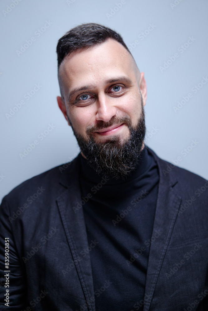 Studio portrait of young handsome man with beard. Studio portrait of young handsome man with beard.