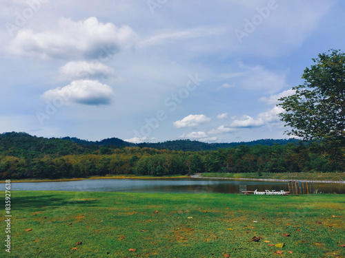 Outdoor activity concept : Travelers are camping tent in greenery season with lake background at Jedkod Pongkonsao , Saraburi, Thailand photo