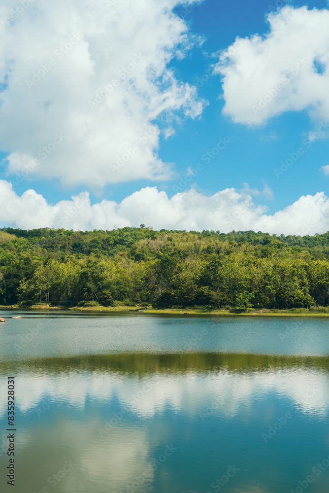 Fototapeta premium Lake with clear blue sky and white clouds, beautiful endless green mountains and waters at Jedkod Pongkonsao Natural Study in Saraburi, Thailand