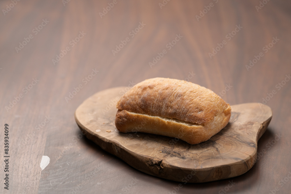 sliced ciabatta bun on wood board closeup sliced ciabatta bun on wood board closeup
