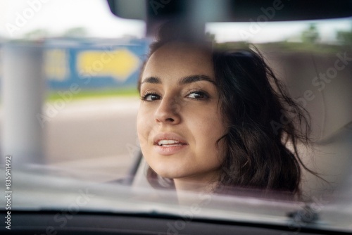 Smiling beautiful young woman enjoying vacations while driving the car. Close up. Road trip, travel, transportation, lifestyle concept © Nataliya