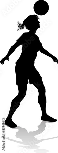 A female soccer football player woman in silhouettes
