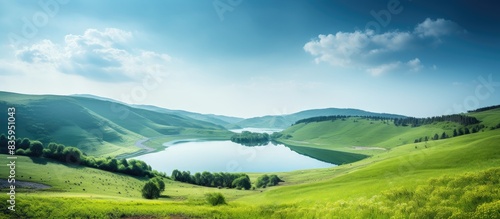 blue lake on a background of green hills. Creative banner. Copyspace image