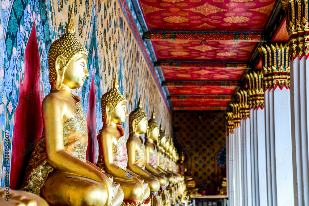 Fototapeta premium Rows of Buddha statues in a Thai temple in Bangkok