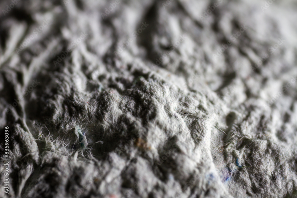 Extreme close up of old gray handmade paper mache with a structure and rough texture. Extreme close up of old gray handmade paper mache with a structure and rough texture.