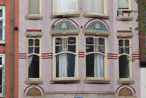 Amsterdam Nieuwezijds Voorburgwal Street Pink Building Facade Detail, Netherlands photo