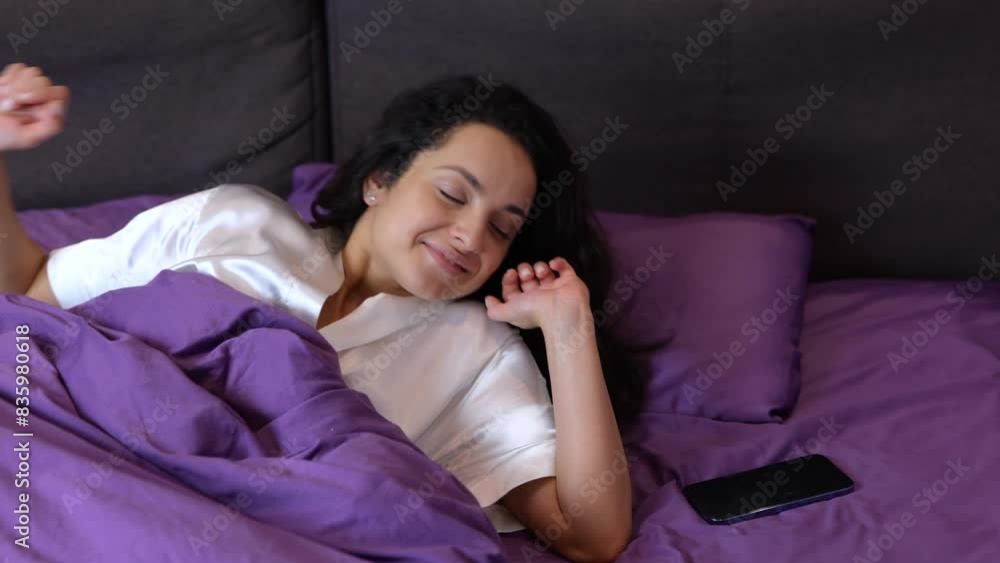 Young woman waking up in bed in the morning, while stretching. Lady taking mobile phone and got angry. Lifestyle, morning routine concept. Slow motion Young woman waking up in bed in the morning, while stretching. Lady taking mobile phone and got angry. Lifestyle, morning routine concept. Slow motion
