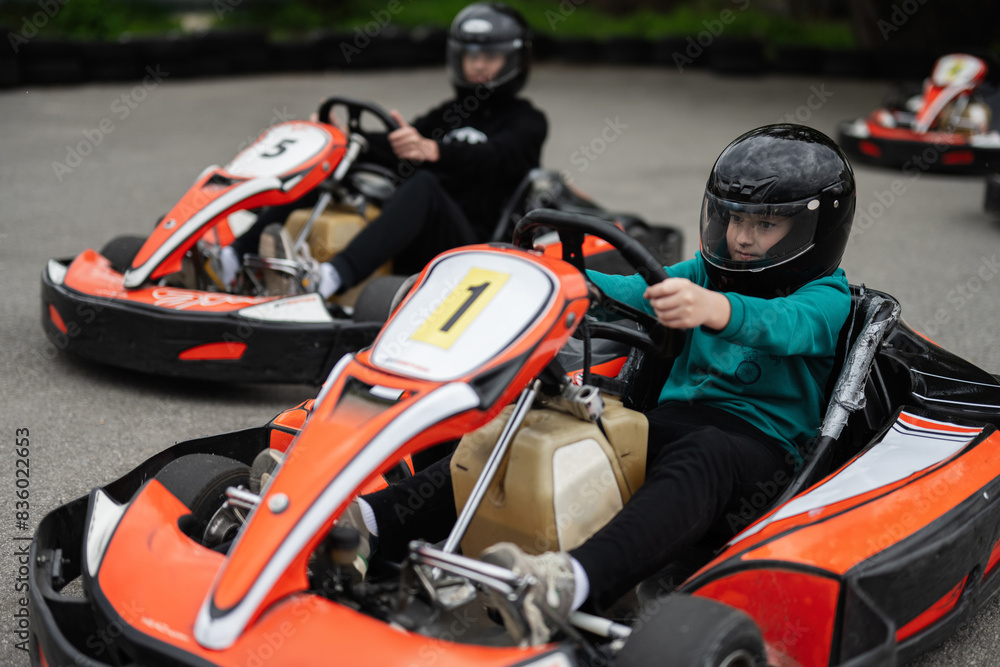 Children Enjoying Go-Kart Racing Outdoors for a Fun and Exciting Adventure Children Enjoying Go-Kart Racing Outdoors for a Fun and Exciting Adventure