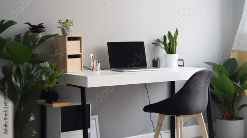 Home office setup with a sleek desk, indoor plants and laptop
