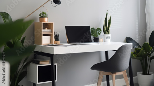 Home office setup with a sleek desk, indoor plants and laptop