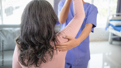 female doctor is helping a patient move her muscles after recuperating from a muscle injury and wanting to rehabilitate her to be able to use her normal daily life with continuous physical therapy.