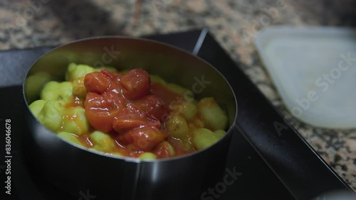 serving gnocchi with the tomato sauce on the plate 