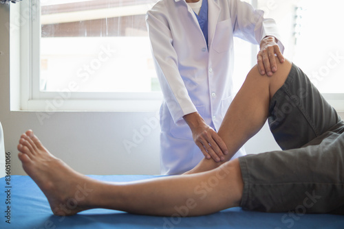 doctor is helping a patient move her muscles after recuperating from a muscle injury and wanting to rehabilitate her to be able to use her normal daily life with continuous physical therapy. © thatinchan