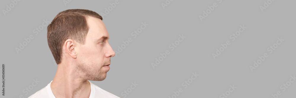 Serious european man. Beauty cosmetology profile portrait. Calm health relax concept. Opened eyes. Male person. Dream about travel. Clean skin procedure. Handsome adult. Grey background Serious european man. Beauty cosmetology profile portrait. Calm health relax concept. Opened eyes. Male person. Dream about travel. Clean skin procedure. Handsome adult. Grey background