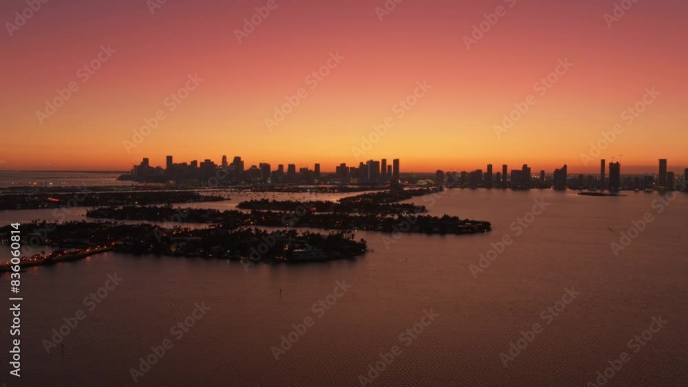 Aerial panoramic view of Miami Venetian Islands and Biscayne Bay at sunset. Silhouette view of Miami Skyline with beautiful pink sky. Florida Miami summer vacation Aerial panoramic view of Miami Venetian Islands and Biscayne Bay at sunset. Silhouette view of Miami Skyline with beautiful pink sky. Florida Miami summer vacation