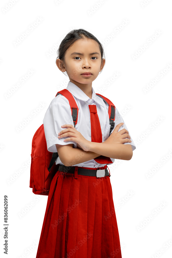 Portrait of an Asian elementary school student girl in uniform with a backpack standing with crossed arms Portrait of an Asian elementary school student girl in uniform with a backpack standing with crossed arms