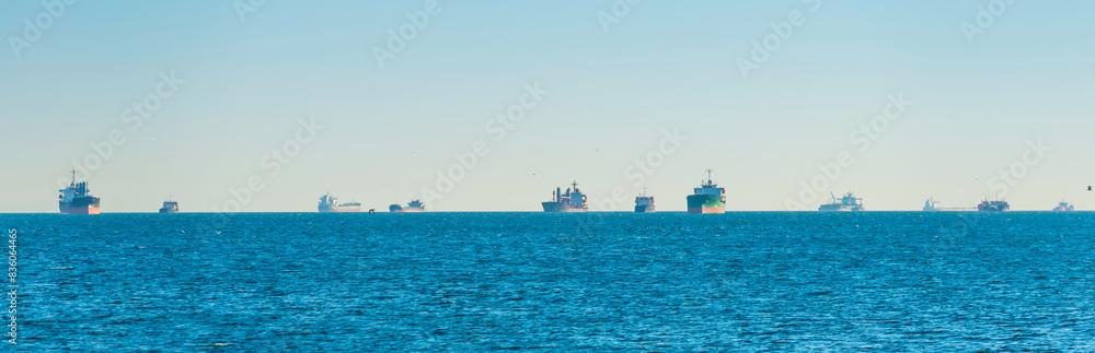 Many transport ships on blue sea, tanker cargo ships panorama
