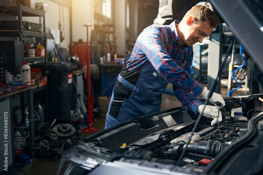 Male repairing motor in car service center Male repairing motor in car service center