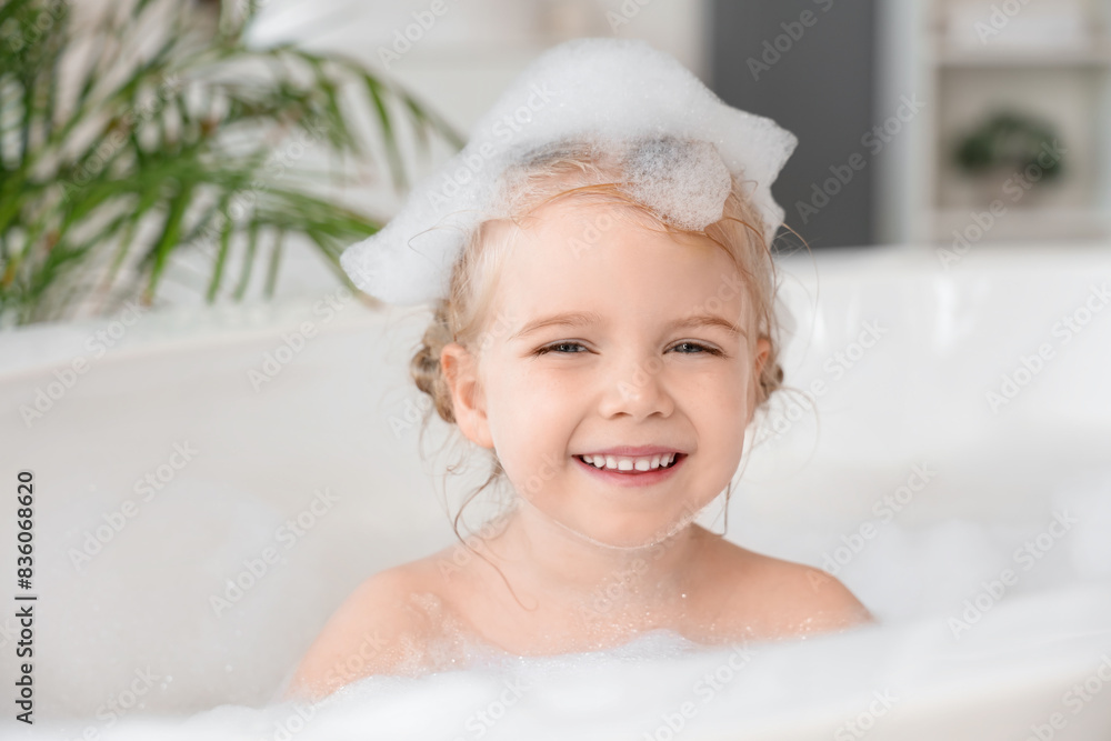 Cute little girl taking bath with foam taking bath in bathroom Cute little girl taking bath with foam taking bath in bathroom