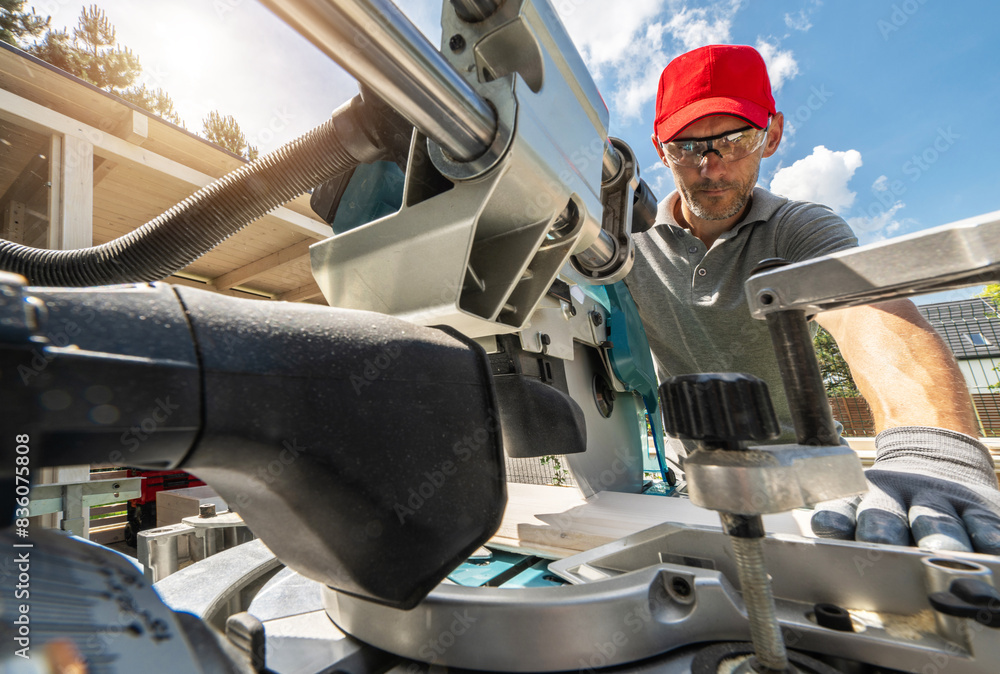 Construction Worker Using Miter Saw Outdoors Construction Worker Using Miter Saw Outdoors