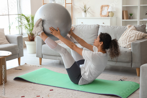 Young woman exercising with...