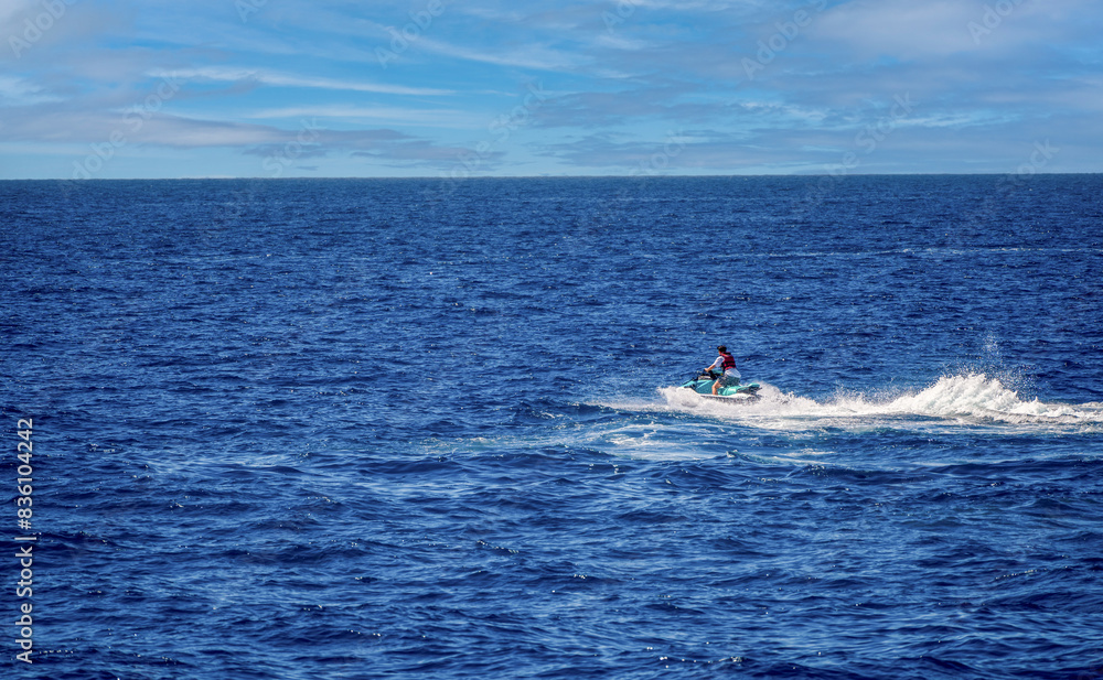 Jet ski in the coastal side of gran canaria puerto against blue sky in Spain, Atlantic ocean