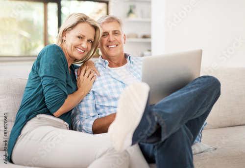 Couple, couch and laptop with portrait in home, streaming and relax in living room for movies. Internet, computer and point for website for video with married people, calm and lounge with technology