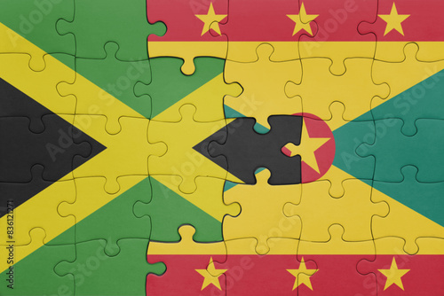puzzle with the colourful national flag of grenada and flag of jamaica . photo