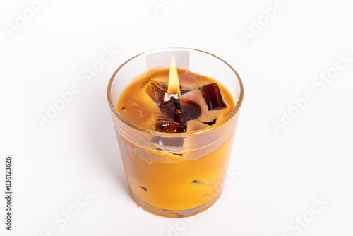 Trendy gel candle in the form of iced coffee on white background