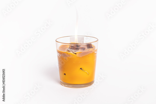 Trendy gel candle in the form of iced coffee on white background. Free space for text