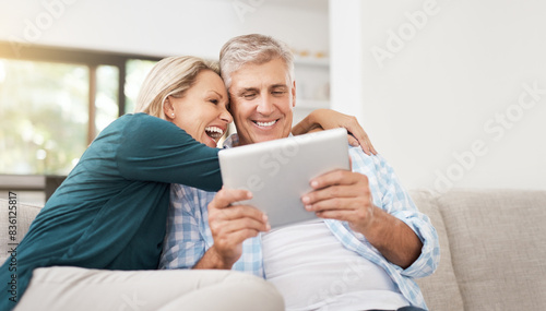 Couple, read and tablet on sofa for social media, laugh and meme online on couch. Technology, internet and app on digital website in home, man and woman person in lounge with touchscreen for comedy