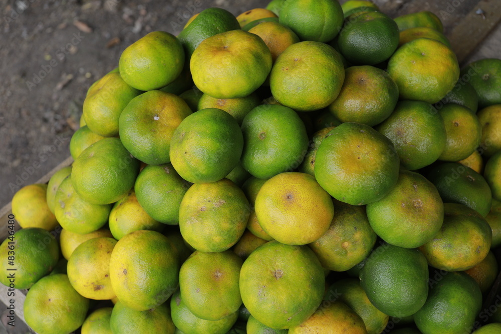 oranges, pile of green peel oranges on the market oranges, pile of green peel oranges on the market