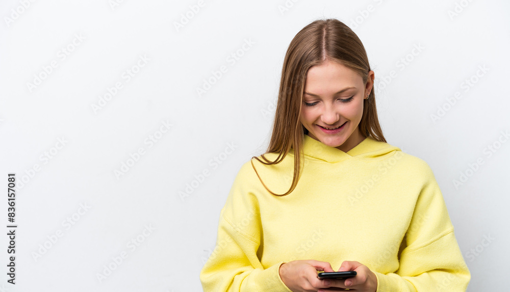 Young Russian woman isolated on white background sending a message with the mobile Young Russian woman isolated on white background sending a message with the mobile